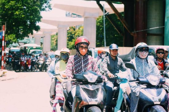 women wearing masks and sun clothing during hot weather in hanoi